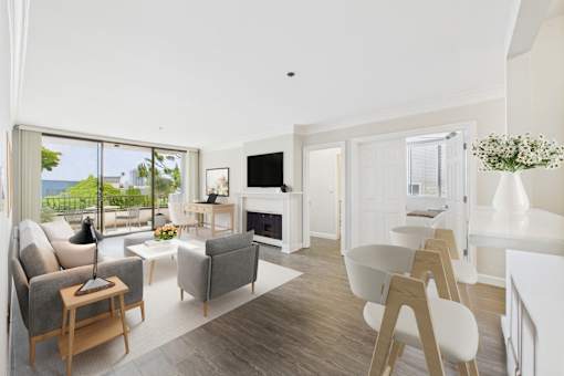 A modern living room with a fireplace and a dining area.