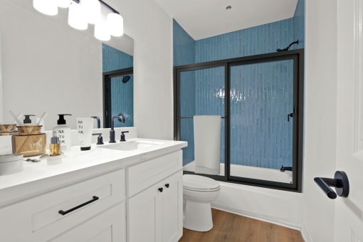 a bathroom with a sink toilet and a shower