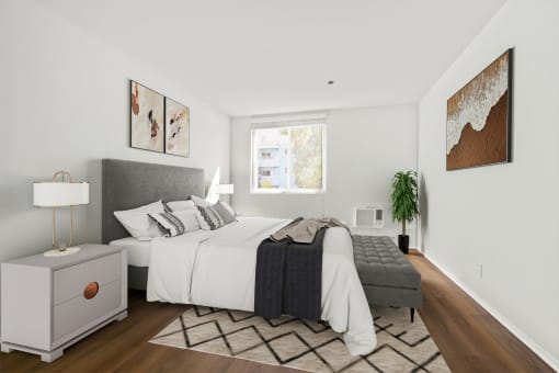 a bedroom with a large bed and a window
