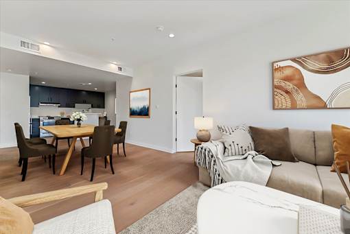 A modern living room with a dining table and chairs.