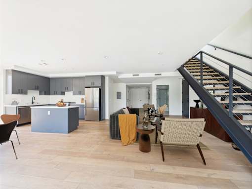 A modern kitchen with a dining table and chairs.