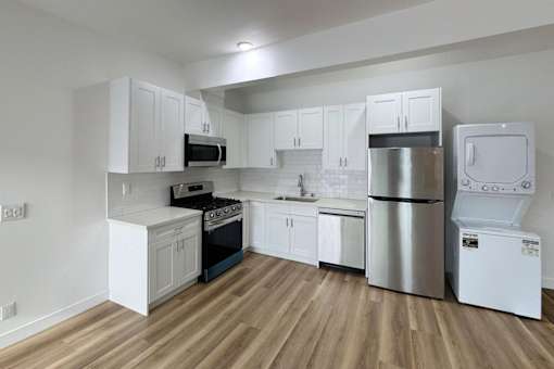 A kitchen with white cabinets and stainless steel appliances.