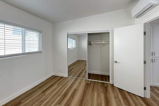 A room with a wooden floor and a white door.