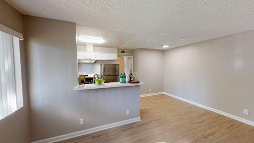 A kitchen area with a counter and a refrigerator.