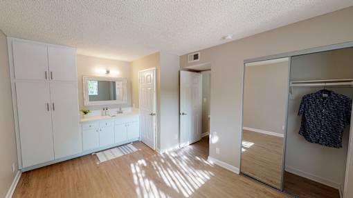 A small room with a sink and a mirror.