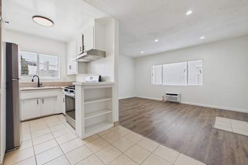A kitchen with a refrigerator, stove, and oven.