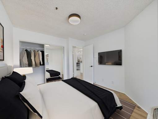 A bedroom with a bed and a wardrobe.