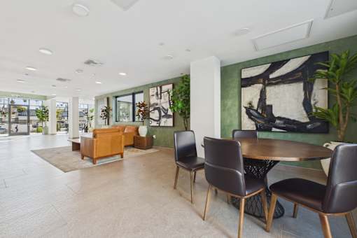 A modern dining room with a table and chairs.
