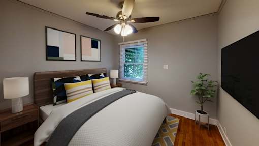 A bedroom with a bed, pillows, a ceiling fan, a nightstand, a lamp, a plant, and a window.