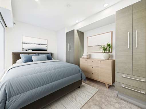 A bedroom with a bed, dresser, and mirror.