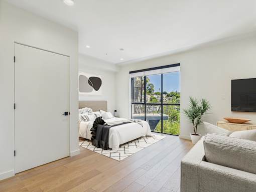 A bedroom with a large bed and a couch.