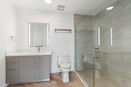 A bathroom with a toilet, sink, and shower.