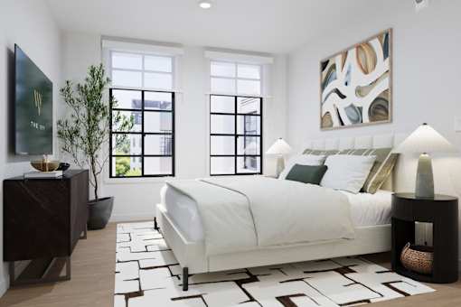 Spacious bedroom with large windows and luxury furnishings