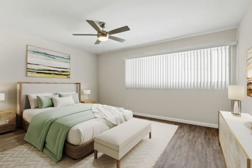 a bedroom with a bed and a ceiling fan