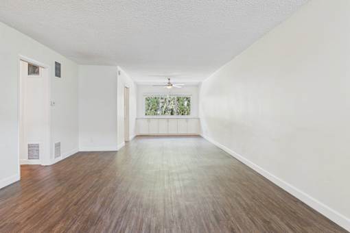 A room with wooden floors and white walls.