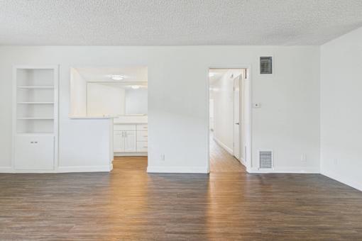 A room with a wooden floor and white walls.