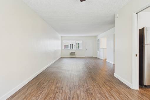 A room with wooden floors and a white door.