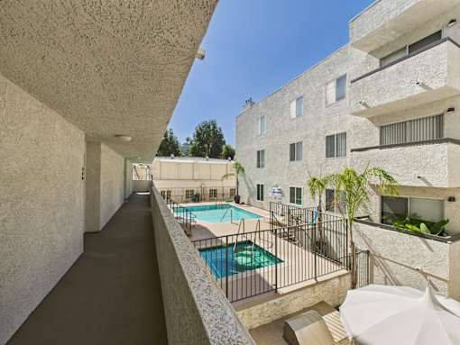A long hallway with a pool on the other side.