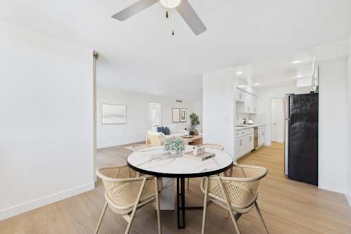 A dining room with a round table and chairs.