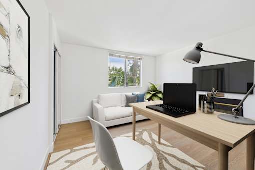 A modern home office with a laptop, a desk, and a chair.