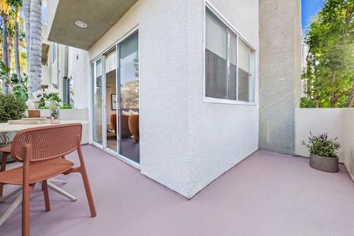 A patio with a chair and a table.