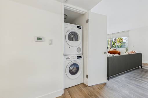 A white washing machine is in a small room.