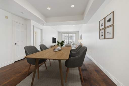 A dining room with a wooden table and chairs.