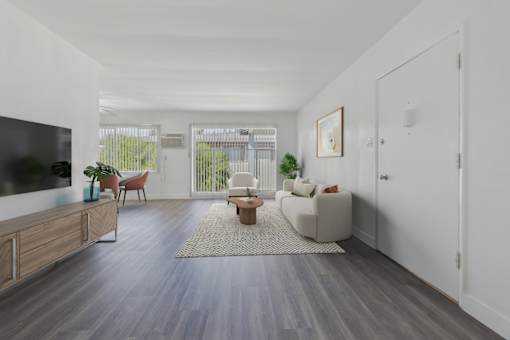 A living room with a grey floor and white walls.