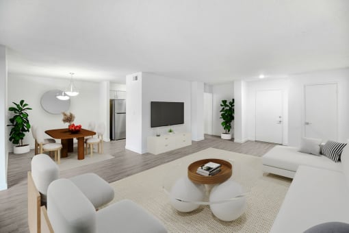 a living room with white furniture and a television