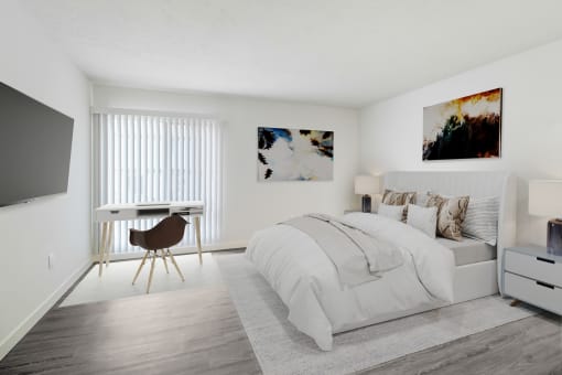 a bedroom with a bed and a desk and a tv