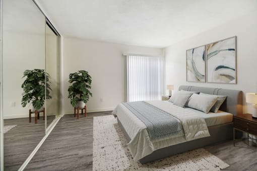 a bedroom with a bed and a large mirror
