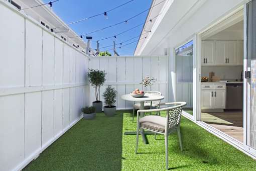 A patio with a table and chairs is shown.