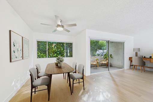 A dining room with a table and chairs.