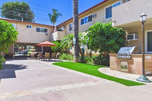 A sunny day at a residential area with apartment buildings and a green lawn.