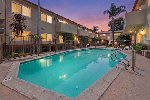 A swimming pool in a residential area surrounded by buildings.