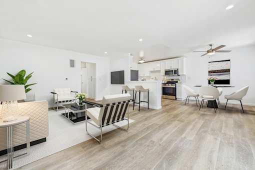 A modern living room with a striped sofa and a television.