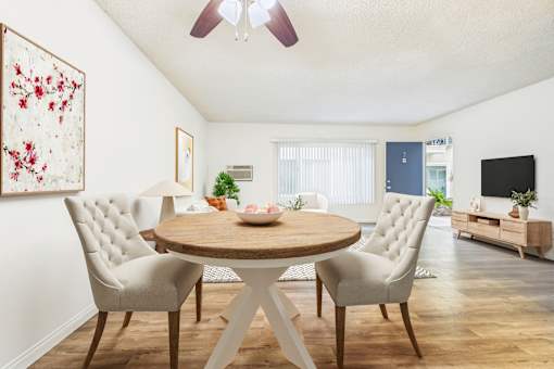 A dining room with a round table and chairs.