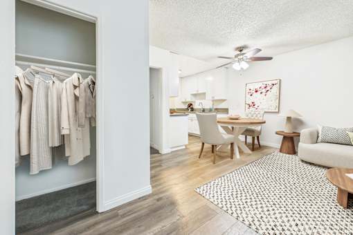 A room with a grey carpet and a wooden floor.