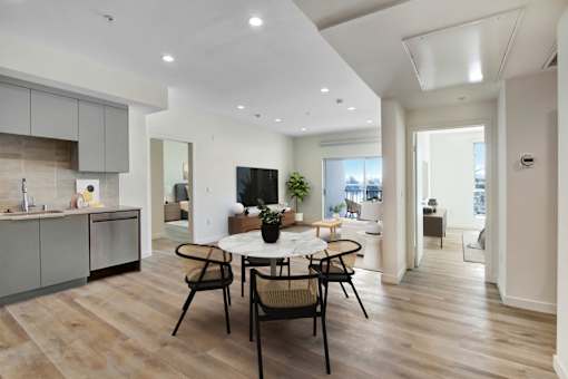 A modern kitchen with a dining table and chairs.