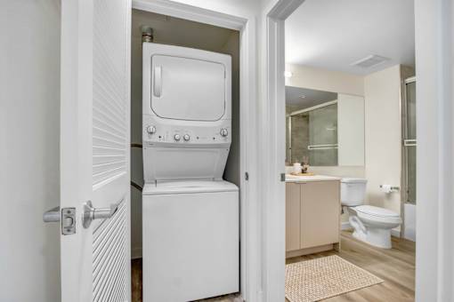 A white bathroom with a walk-in shower and a toilet.