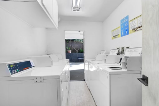 a laundry room with washing machines and other appliances