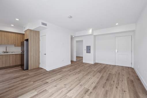 A room with wooden floors and white walls.