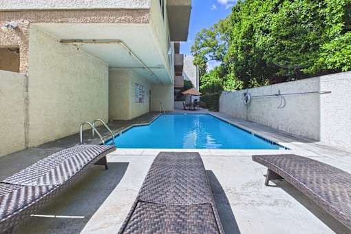A small pool with a metal diving board.