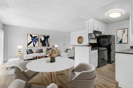an apartment living room and kitchen with a table and chairs