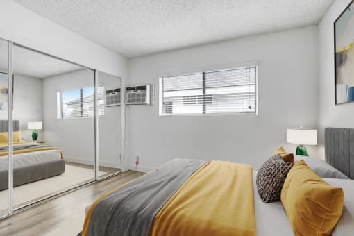 a bedroom with two beds and a mirror