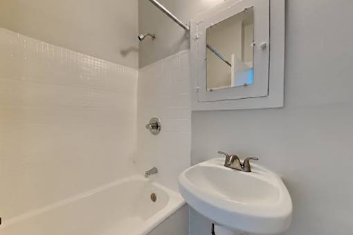 A white sink with a mirror above it in a bathroom.