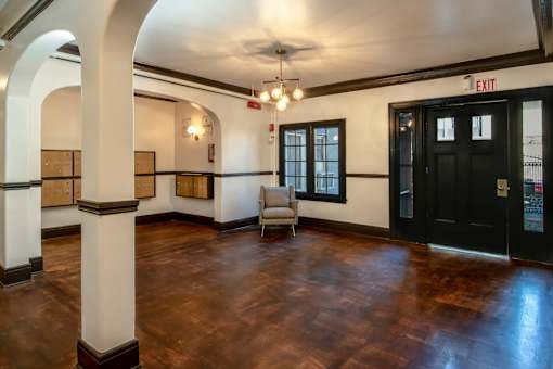 A room with a wooden floor and a ceiling fan.