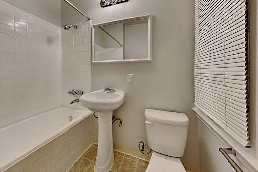 A white sink and toilet in a small bathroom.