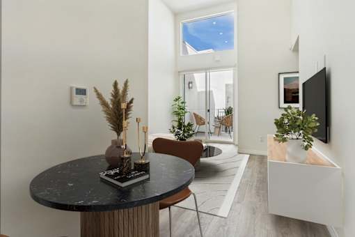 A modern dining room with a round table and chairs.