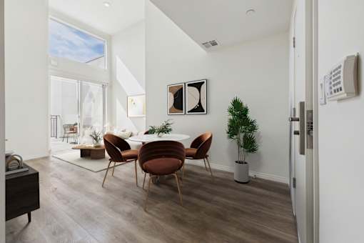A modern dining room with a wooden table and chairs.